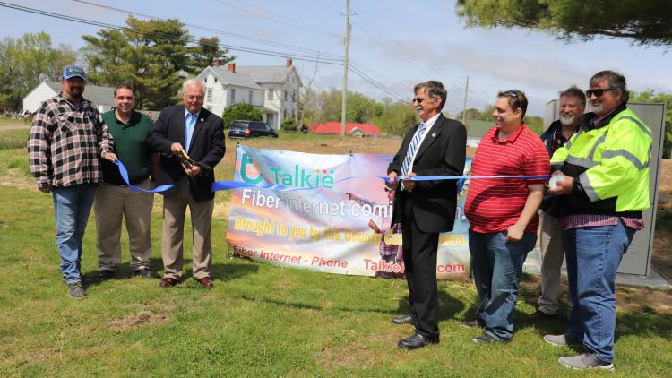 Worcester County Commissioners and Talkie Communications professionals cut the ribbon to celebrate the newly-installed fiber-optic broadband cabinet at the Bishopville Park